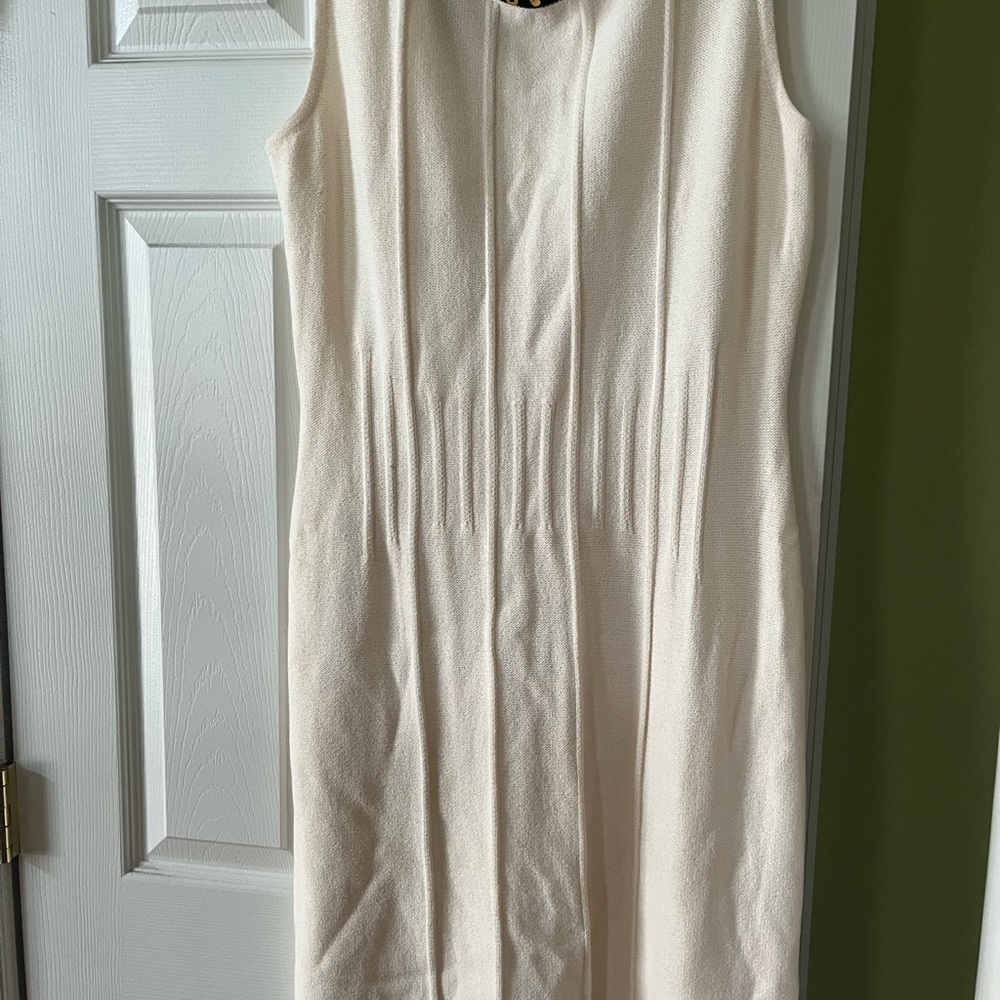 Off white knee length dress navy collar with a gold small buckle at the neck.